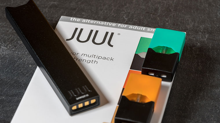 Box holding JUUL nicotine dispenser and pods